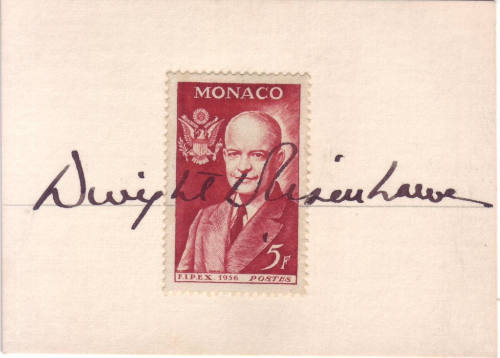 EISENHOWER, DWIGHT D. Signature, as President, written on a small card across a 5-franc postage stamp from Monaco showing the bust of E